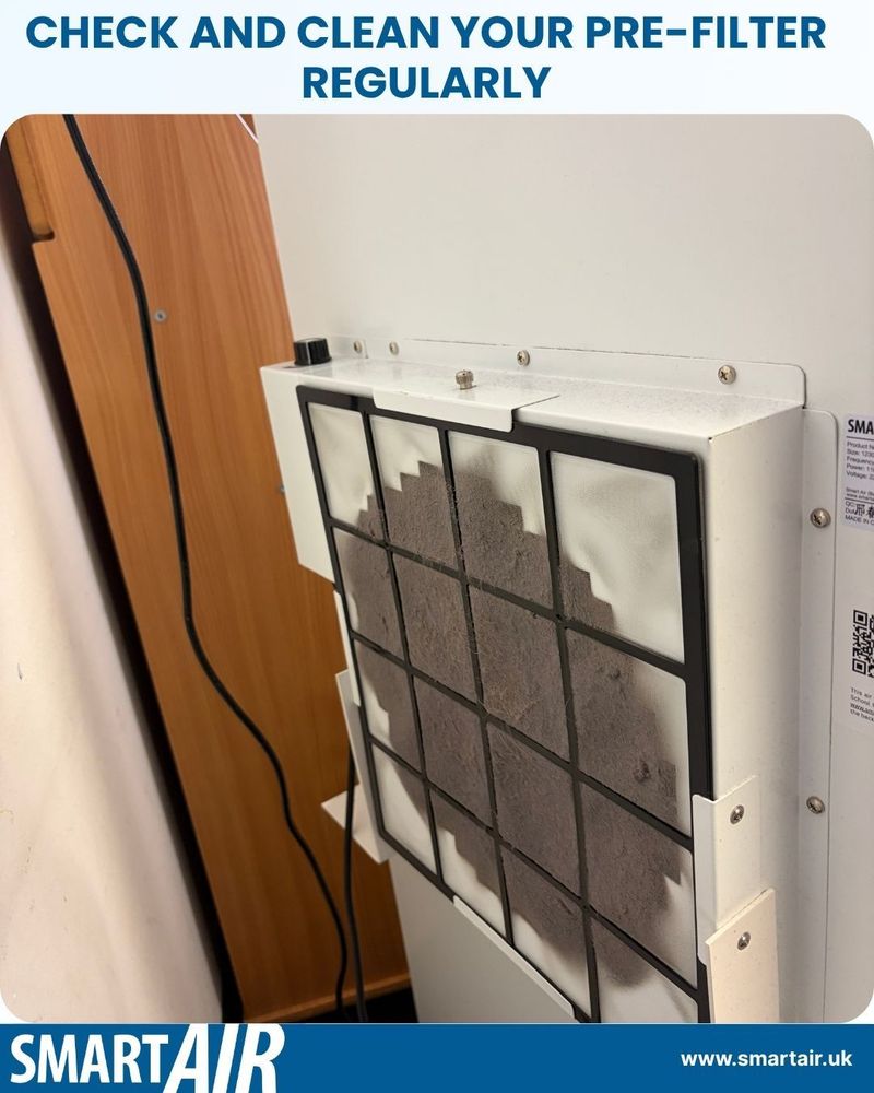 Close-up of the Blast air purifier by Smart Air showing a dusty pre-filter that needs cleaning. The text at the top reads “Check and clean your pre-filter regularly,” reminding users to maintain their air purifier for optimal performance. The Smart Air logo and website are displayed at the bottom.