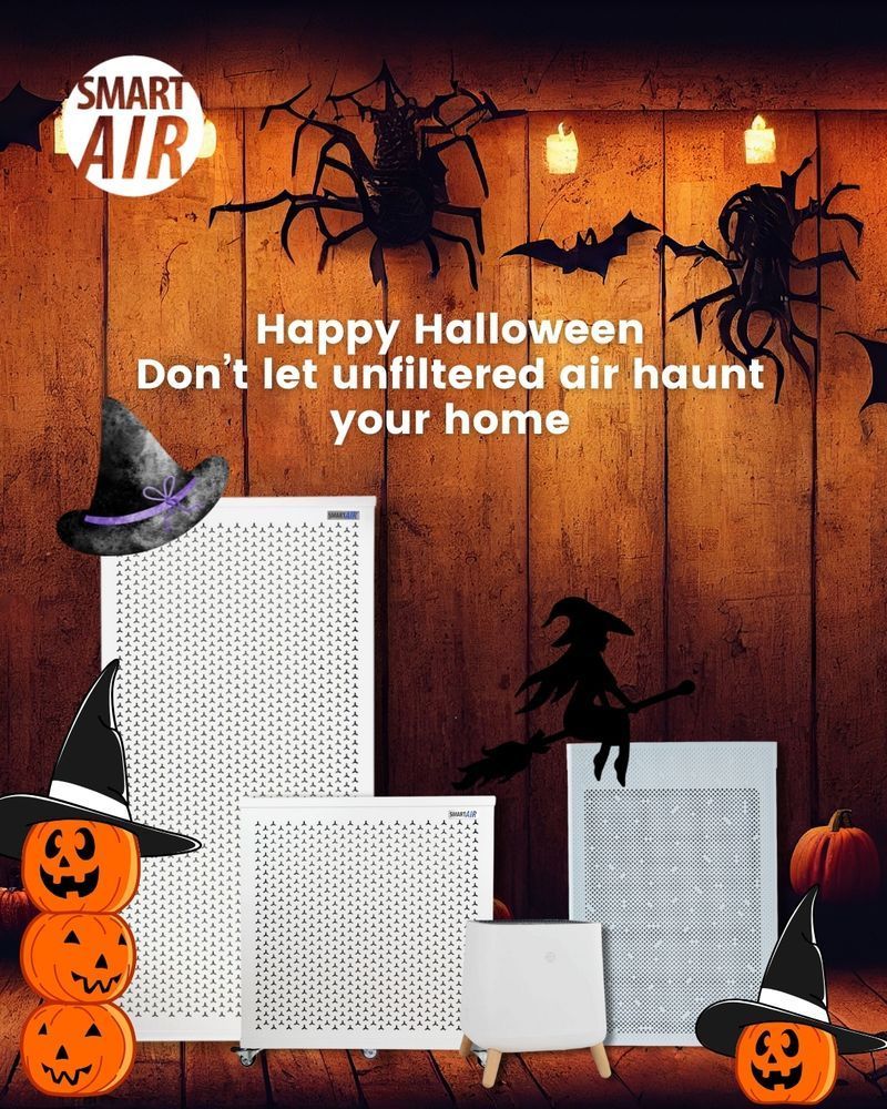 Halloween-themed image featuring Smart Air purifiers decorated with pumpkins, witches’ hats, bats, and spiders against a wooden backdrop with candlelight. The text reads “Happy Halloween – Don’t let unfiltered air haunt your home,” with the Smart Air logo in the top left corner.