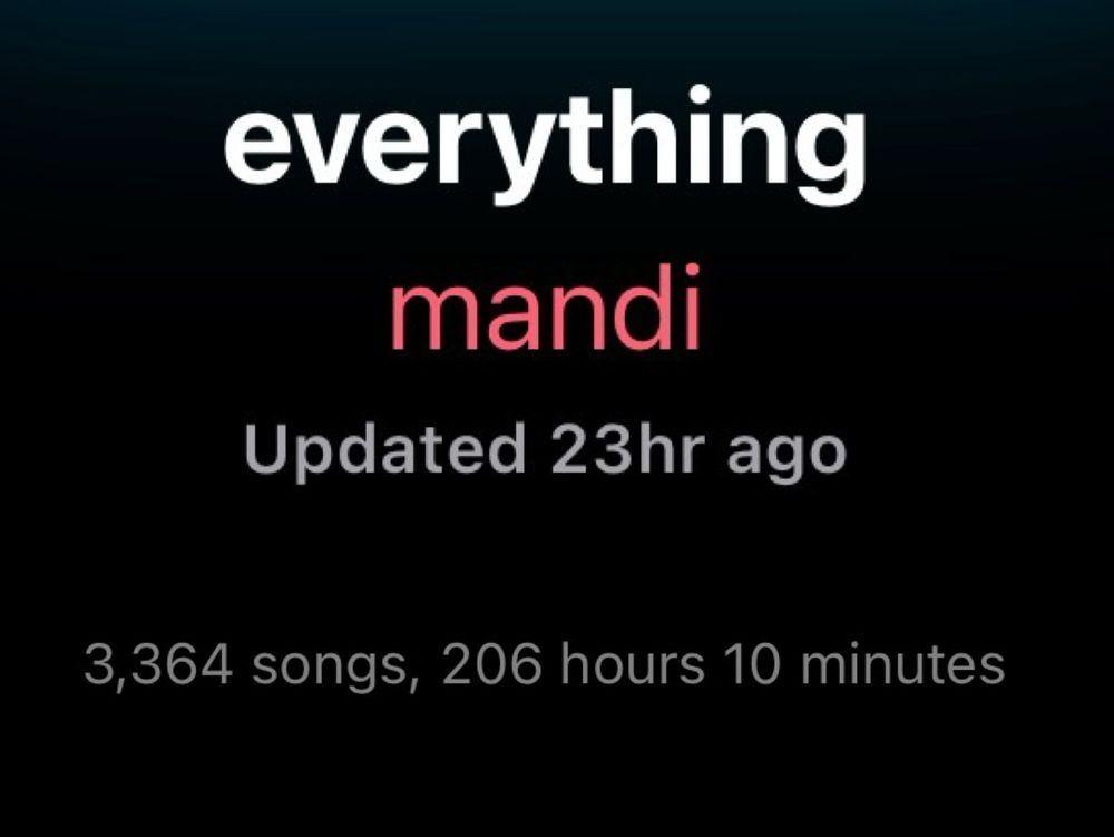 [Text on black background centred to the image]

[white text]
everything 

[red text]
mandi

[grey text]
Updated 23hr ago
3,364 songs, 206 hours 10 minutes