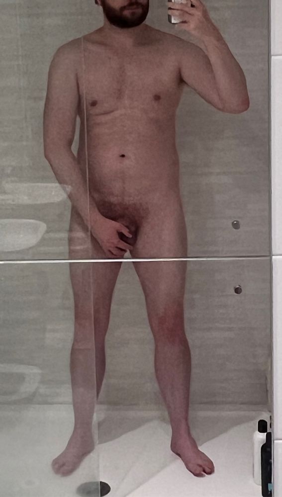 A naked man in the shower