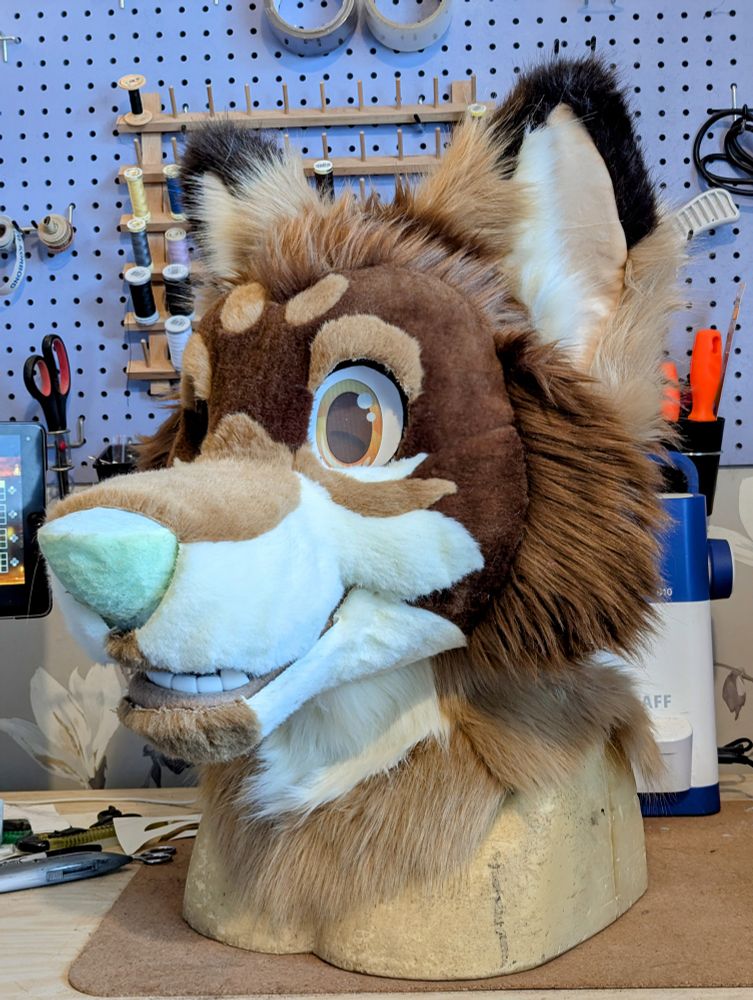 A WIP of an unglued, scruffy fursuit head of a brown and tan toony coyote