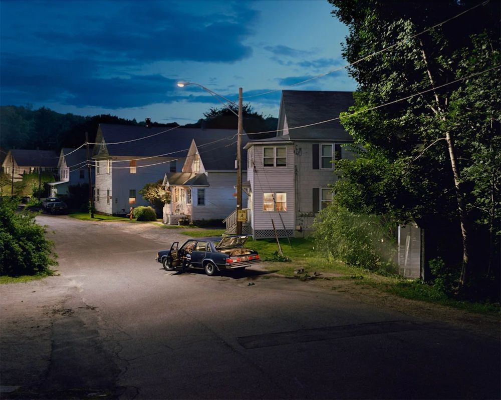 photography of a car outside houses in the suburbs by Gregory Crewdson