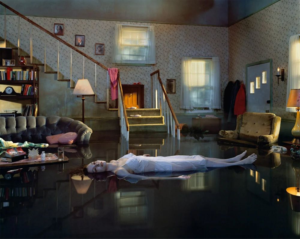 photography of a woman floating in a flooded living room by Gregory Crewdson