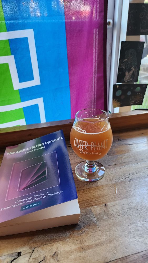 A DIPA at Outer Planet on its last day. Seattle Pride flag and customer art in the background. I'm reading The Authoritarian Dynamic by Karen Stenner.