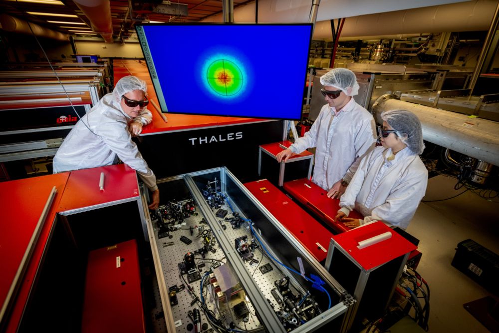 (Left to Right) Anthony Gonsalves, Staff Scientist, Accelerator Technology and Applied Physics (ATAP), Alessio Amodio, Electronics Engineer, Engineering Division, and Dan Wang, Research Scientist, ATAP, discuss the set up of the PW Laser at the Berkeley Lab Laser Accelerator (BELLA) center. Photo: Thor Swift, Berkeley Lab. 