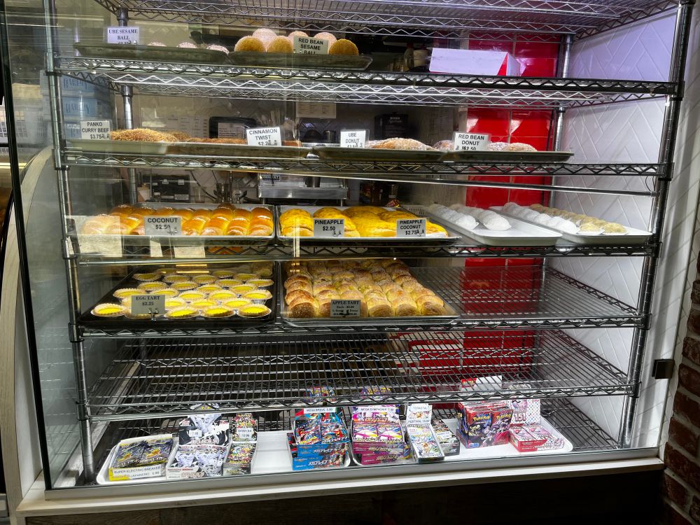 Bakery items with Pokemon cards on a shelf 