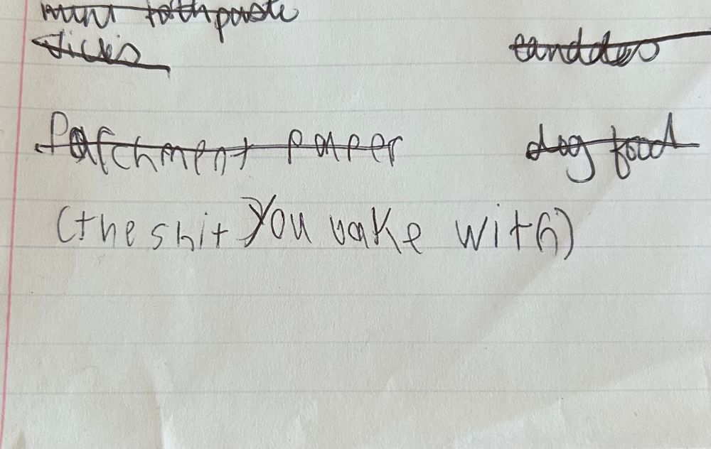 Cropped picture of a shopping list that my son added parchment paper (the shit you bake with) to.