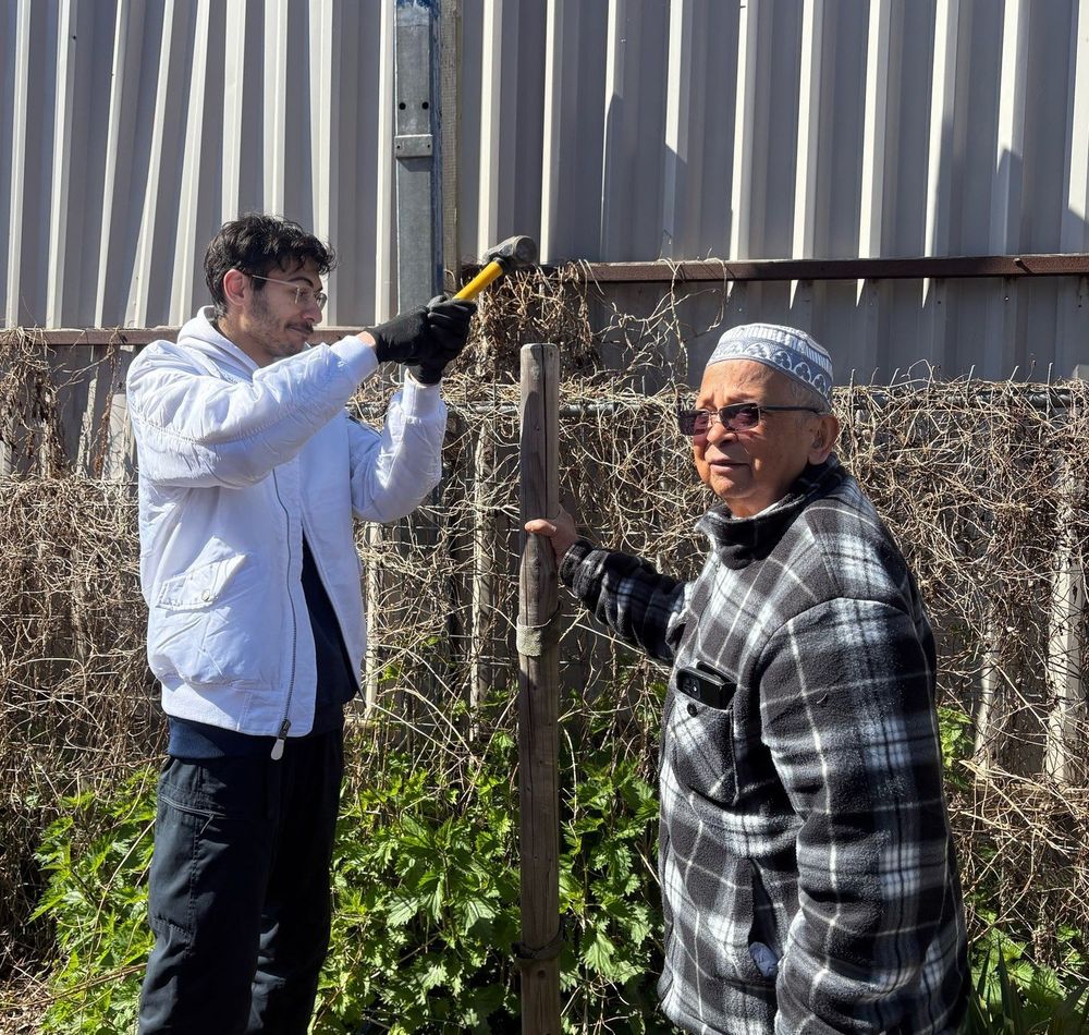Members of the local community putting in tree stakes.