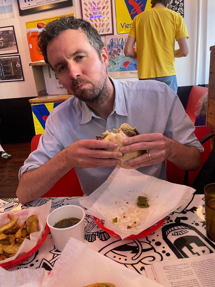 my friend john eating an italian beef sandwich