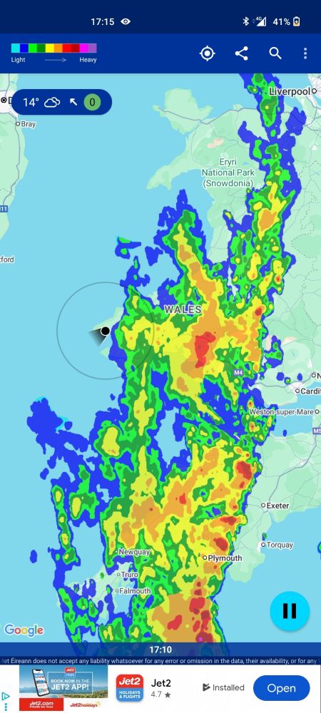 Weather radar showing heavy rain over all of Wales except for the tip down by St. Davids. A little indicator shows my location on that tip with no rain.