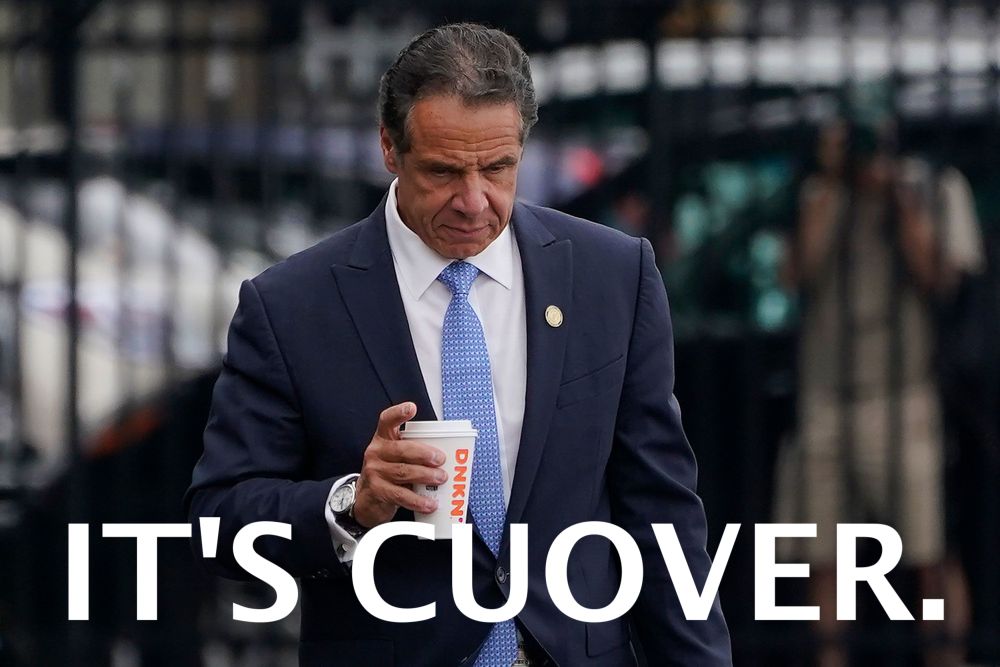Andrew Cuomo looking down while holding a cup of Dunkin, with the caption "It's Cuover."