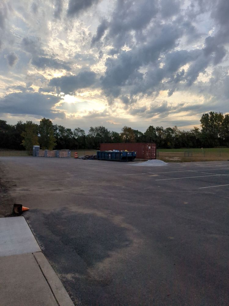 A picture of the sunrise with a tree line in clouds.
