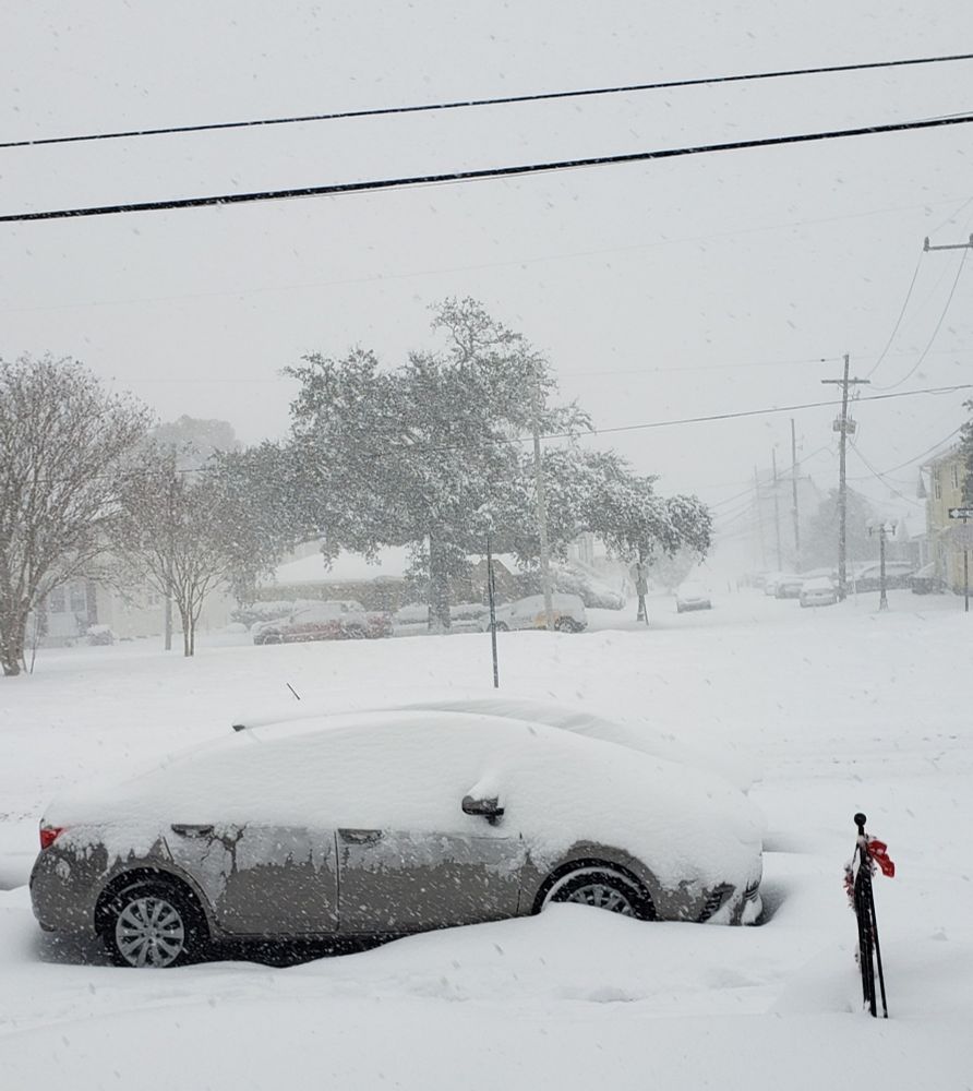 Silver car getting covered with snow in New Orleans ❄