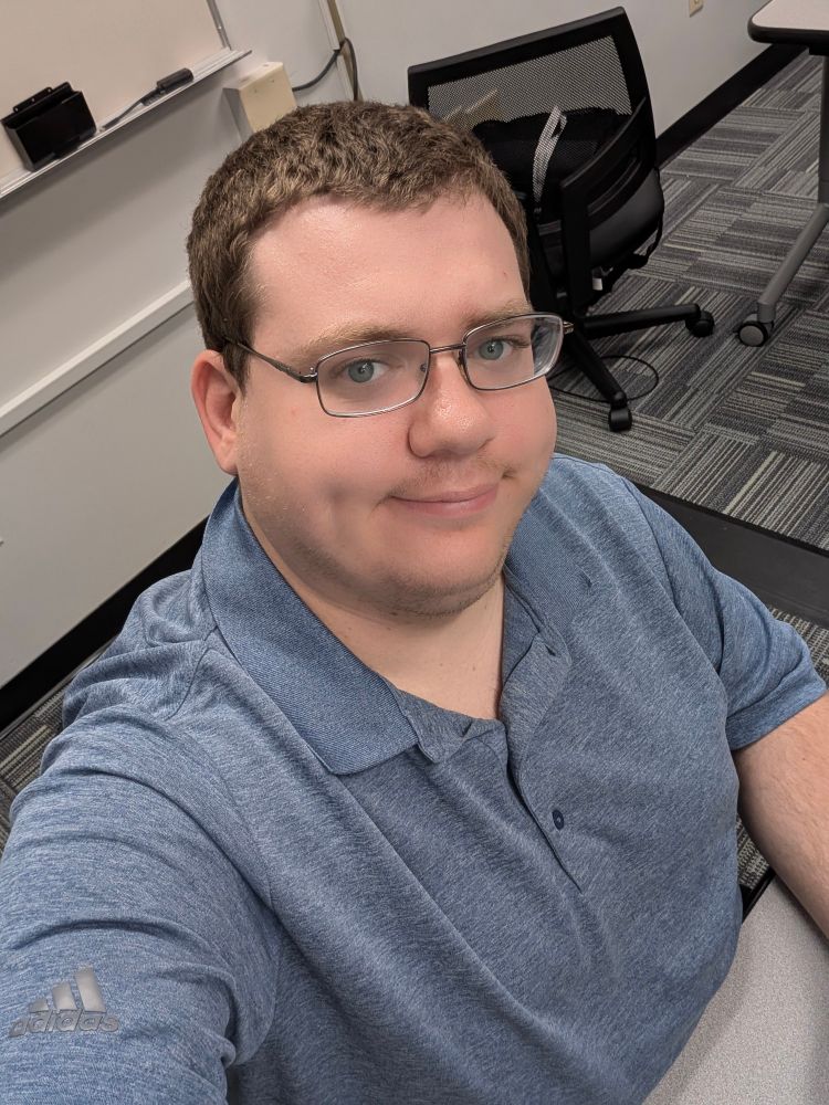 A selfie of me in a blue gray polo