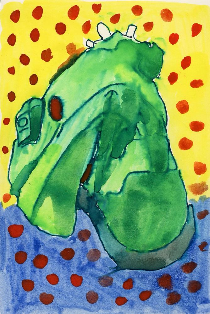 A green boot by TMA Eyes folded over about halfway up. Behind the boot is an upper background in yellow, lower in blue, both covered in orange polka dots.