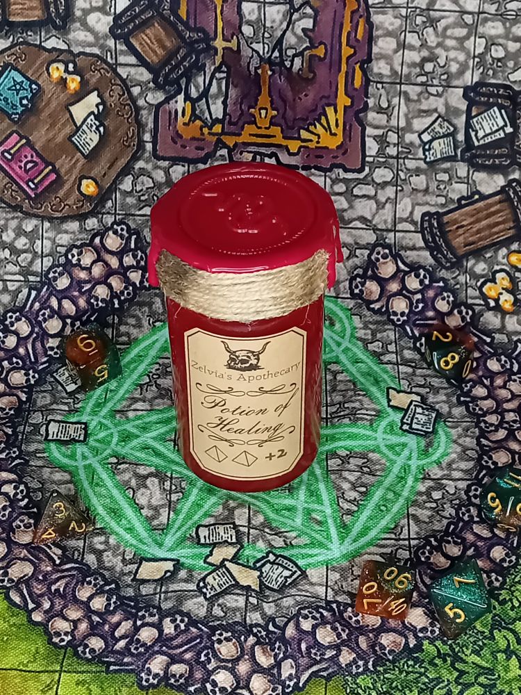 A Potion bottle sits on a background of stone bricks, in the middle of a glowing green spell circle. The potion is red, with a label reading "potion of healing". The top of the potion is wrapped in string and sealed with a red wax.
