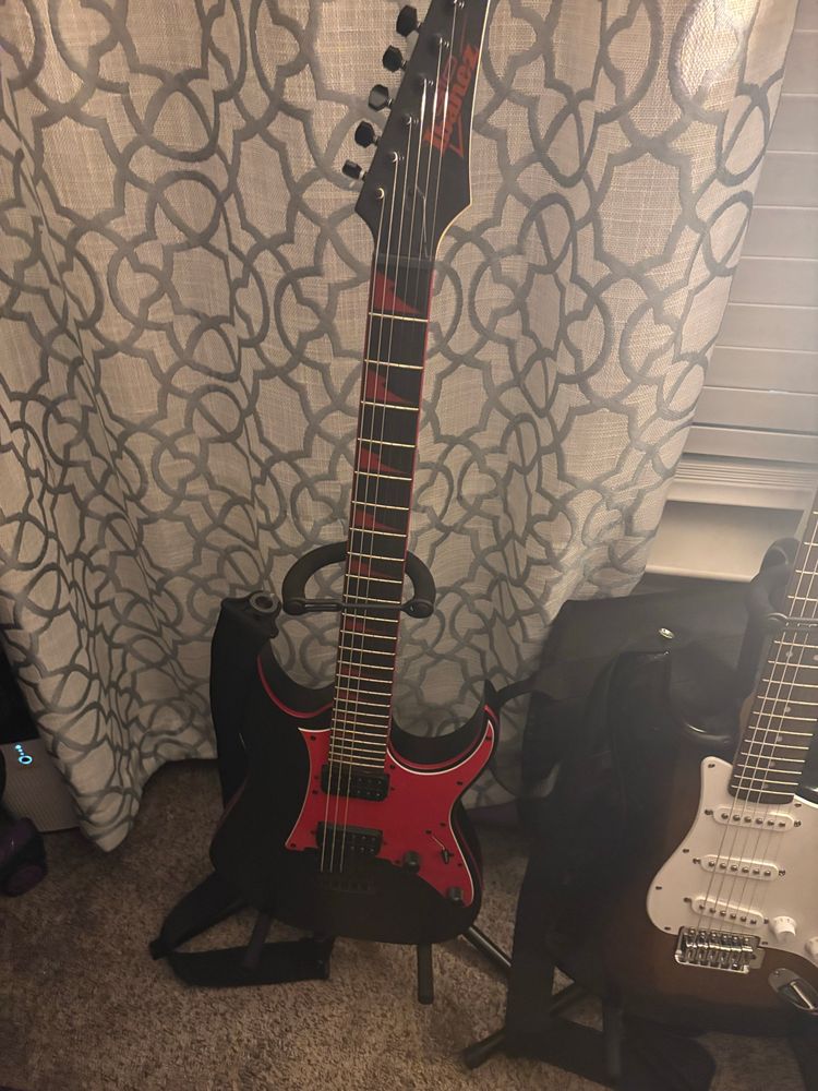Ibanez GRG131DX 6 string next to my first guitar a Fender Squier