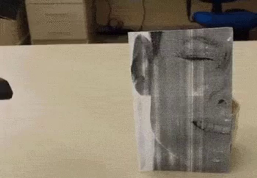 a piece of paper with a picture of a person 's face on it