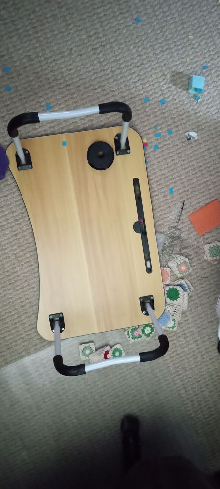 Upside down lap table with the contents spread over the floor. Sigh