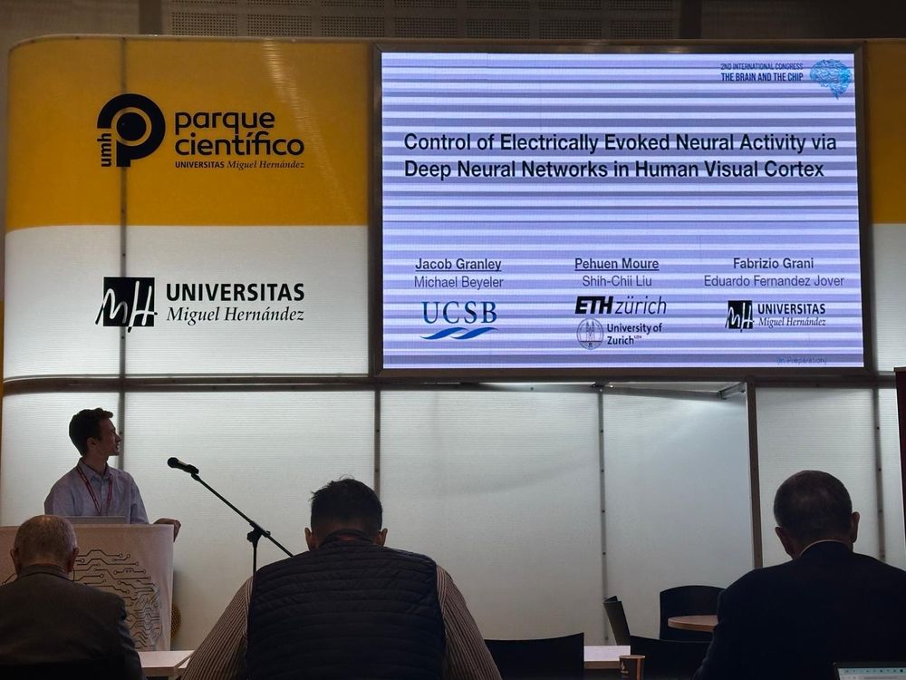 Jacob Granley from the Bionic Vision Lab presenting at the podium as he presents his talk on control of electrically evoked neural activity via deep neural networks in human visual cortex