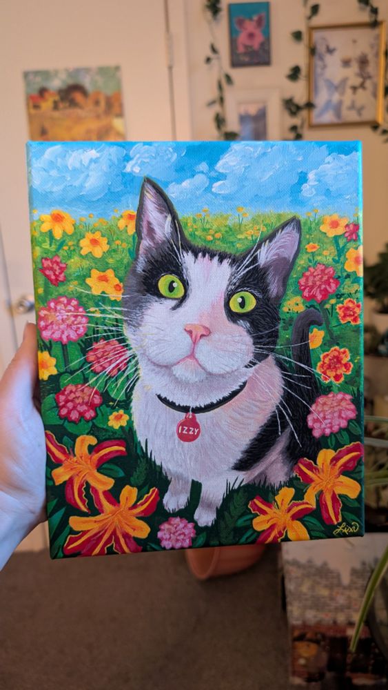 An acrylic paint of a black and white cat with green eyes sitting in a field of flowers. There is a bright sky with light clouds in the distance.