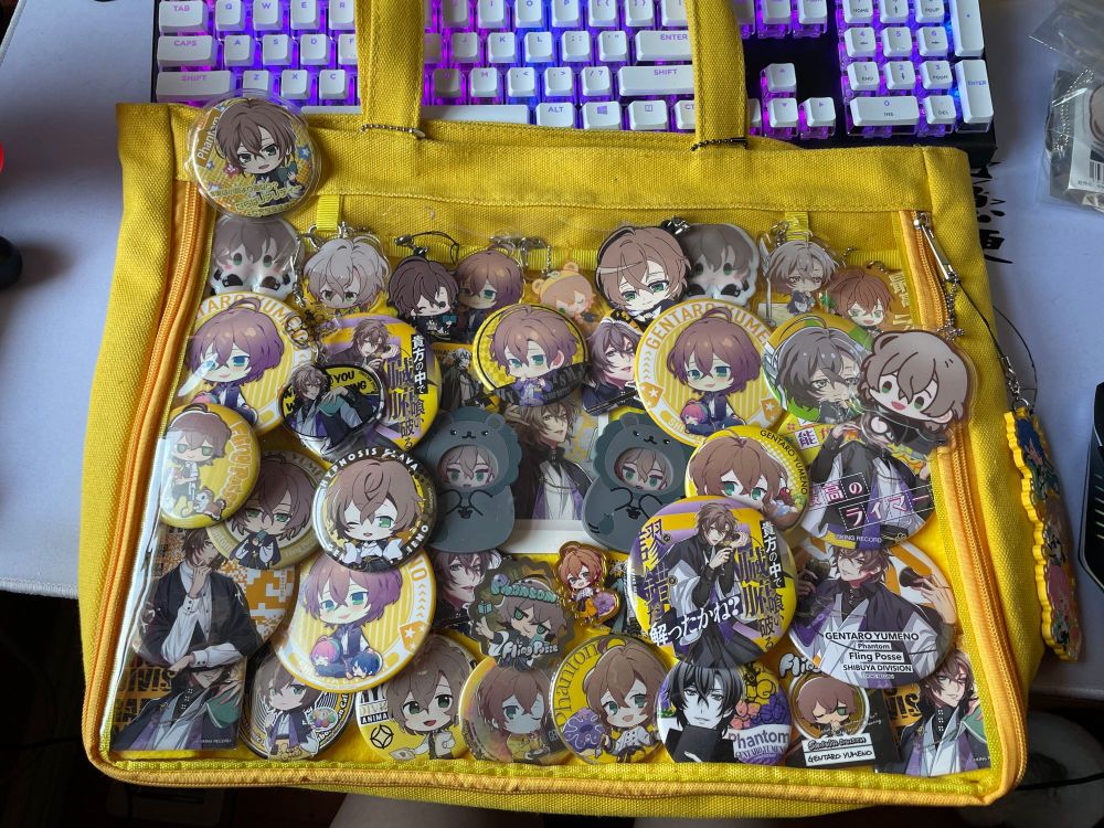 a large yellow bag with a large plastic window, showcasing merchandise of Yumeno Gentaro from Hypnosis Microphone