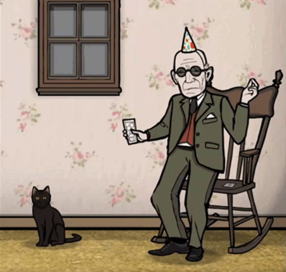 a man in a party hat is sitting in a rocking chair with a black cat