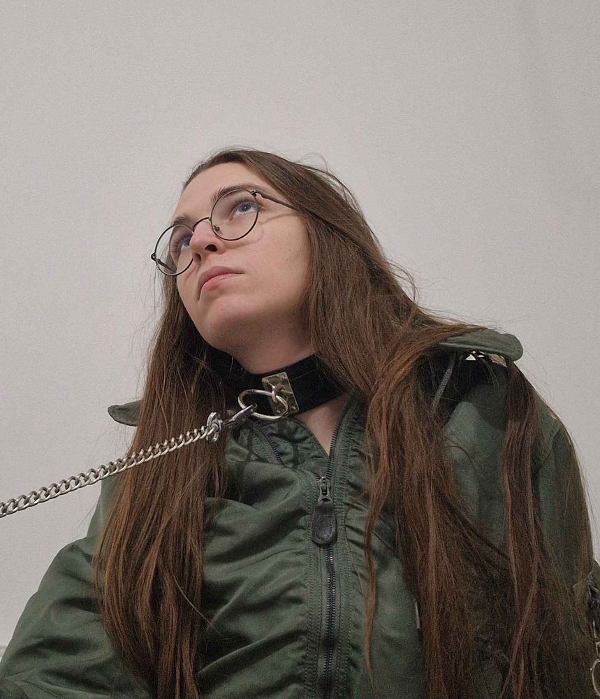 another selfie ! this time the jumpsuit is less open, the leash is taught outside of the shot. i'm looking up to a potential other person.