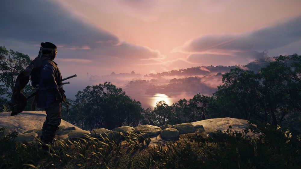 Ghost of Tsushima screenshot: Jin overlooking the island where it is overcast and you can see the sun in the ocean's reflection