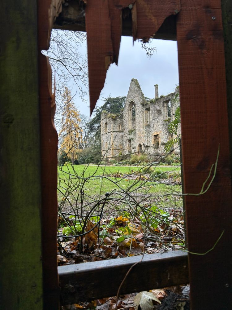 A hole in the fence at the rear of Southwell Minster, promising a journey into deep time.