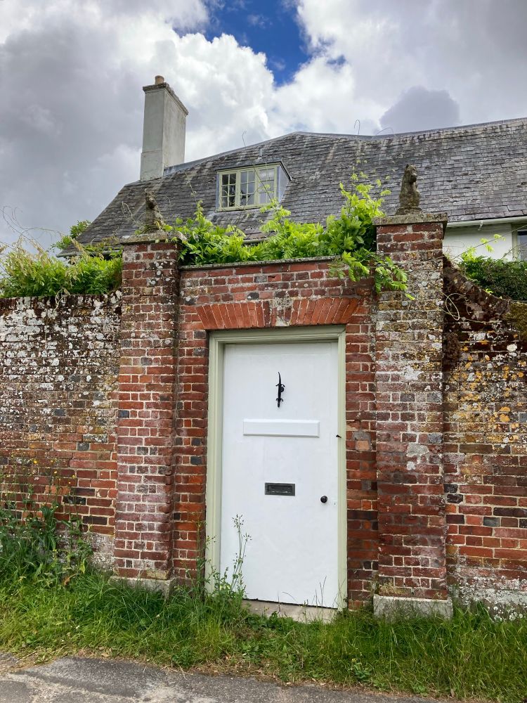 An intriguing door in a neat but lovely old wall.