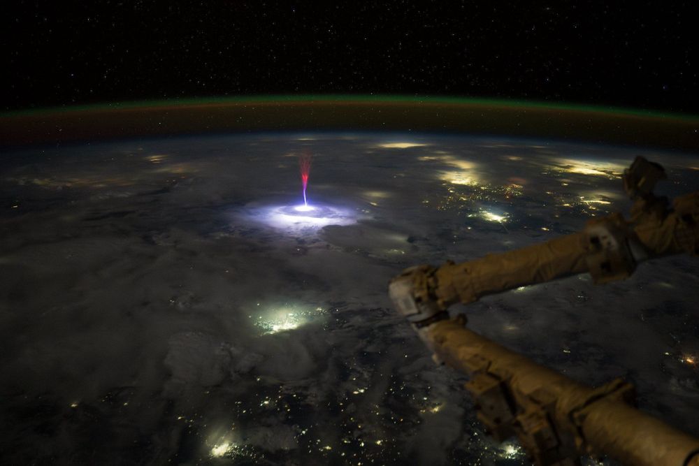 Description by Simeon Schmauß (https://www.flickr.com/photos/semeion/54664805569/):
On July 3rd, astronaut Nichole Ayers photographed a gigantic jet from the ISS. These rare upward directed electrical discharges extend ~90-100 km high into the mesosphere.

The jet originated from a thunderstorm over Northern Mexico, with city lights from South Texas and the green airglow layer visible along Earth’s limb.

I processed this image from the RAW file, adjusting the color profile, white balance and contrast and applied Lightroom's machine learning denoise with low strength.

The RAW was provided to me by Frankie Lucena, his analysis of the event, correlating it to measurements from the Geostationary Lightning mapper and ELF-VLF radio signals can be found here: https://spaceweathergallery2.com/indiv_upload.php?upload_id=224355

City annotations referenced from Riccardo Rossi:
https://x.com/RikyUnreal/status/1942367538714734609

Original image listing in the NASA archive: https://eol.jsc.nasa.gov/SearchPhotos/photo.pl?mission=ISS073&roll=E&frame=281502

Credit: Nichole Ayers / NASA JSC / ESRS / Simeon Schmauß
