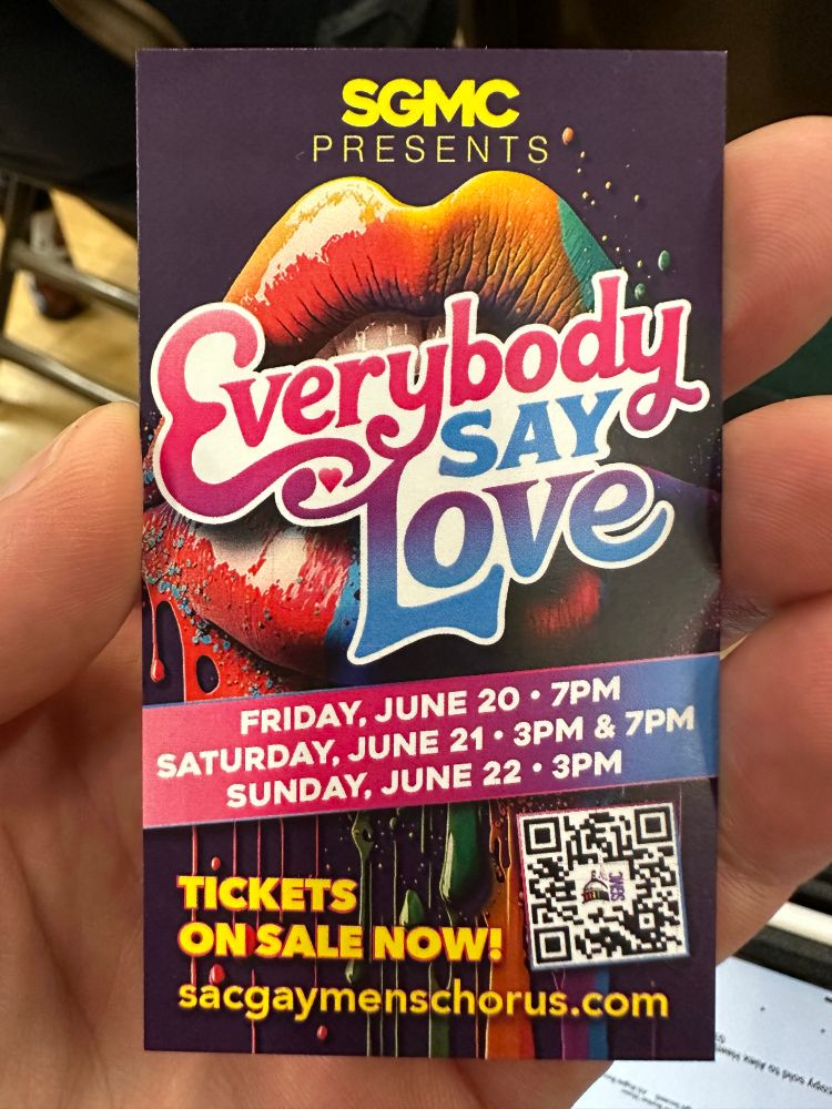 The photo shows a business card advertising ‘Everybody Say Love,’  the Sacramento Gay Men’s Chorus summer concert series at The Sofia - 4 shows - June 20-22. 