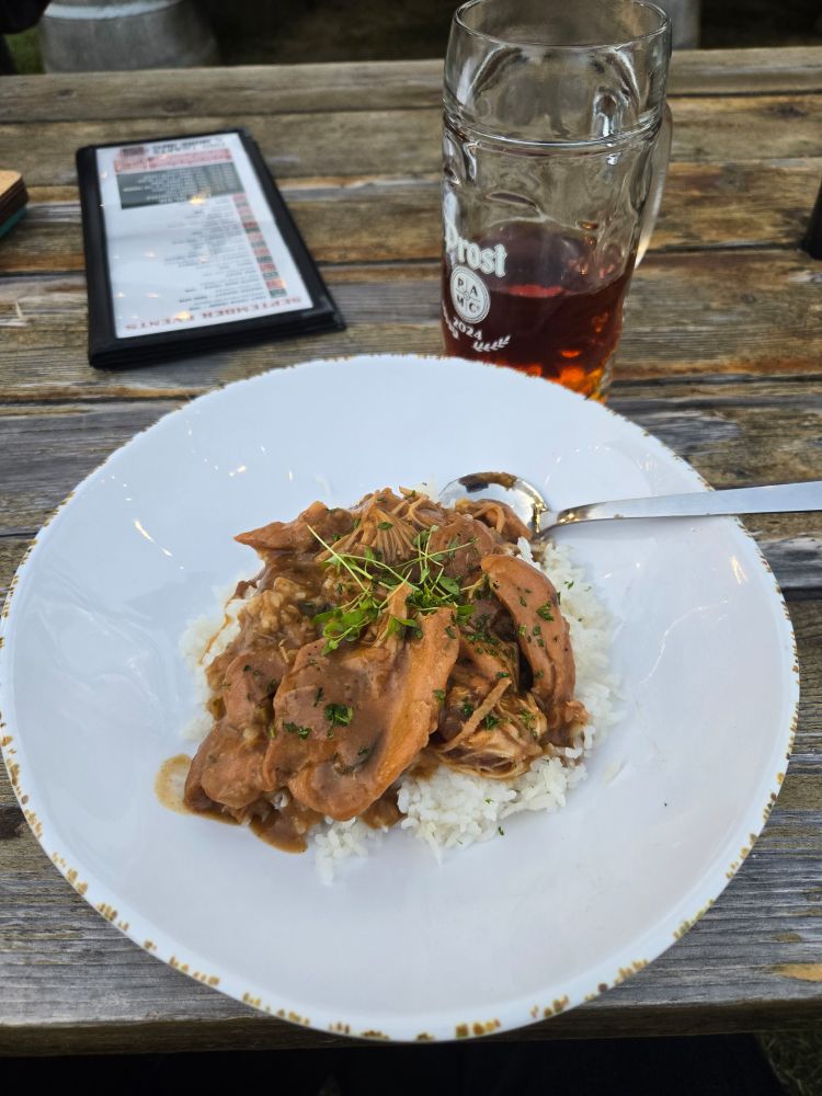 Bowl of chicken gumbo and am almost empty stein of beer. 