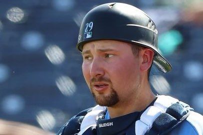Cal Raleigh in this catching gear, mask off, giving a WTF face, looking to the side and lip curled