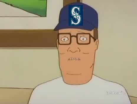 Hank Hill wearing a Mariners cap, eyes bulging, biting lip