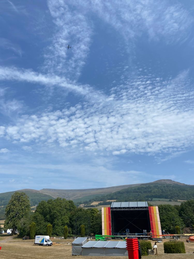 The Mountain Stage at the Green Man Festival as a plane (big plane, bomber maybe) sails past.