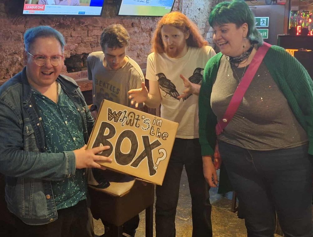 Friz Frizzle, Tom Little, Alasdair Beckett-King and Leslie Ewing-Burgess looking in a box