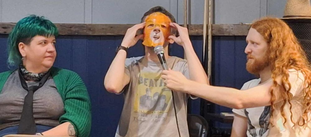 Tom Little putting on a cat mask