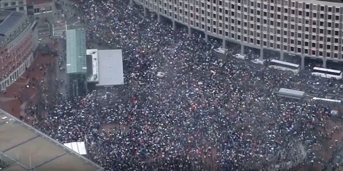 Protest in Boston, Massachusetts showing thousands of people filling the streets and commons.