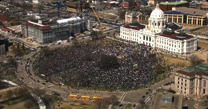 Protest on April 5, 2025 in front of the Minnesota Capitol, thousands of protestors filling the grassy area in front of the capitol, hundreds more on streets in distance still marching to capitol.