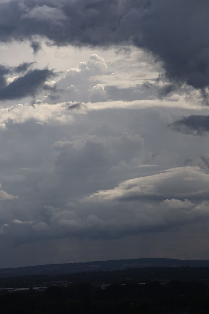 View towards the hill with layers of dark clouds