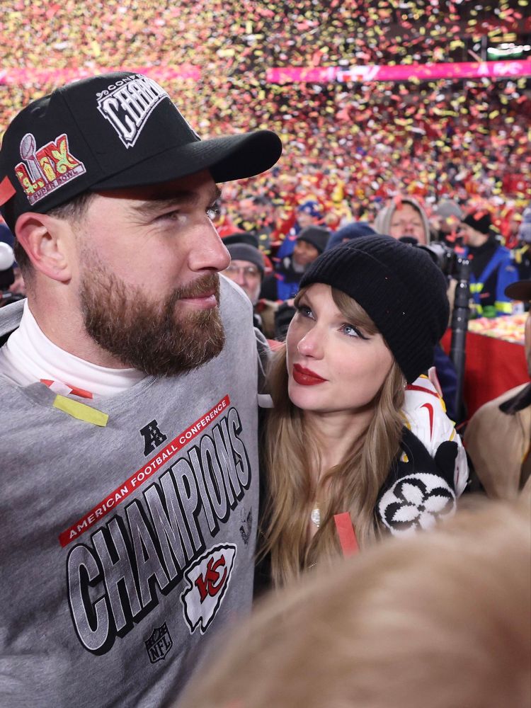 Taylor Swift and Travis Kelce celebrating Kansas City Chiefs’ AFC Championship win. Taylor is seen gazing up at Travis. An explosion of yellow and red confetti is seen in the background.