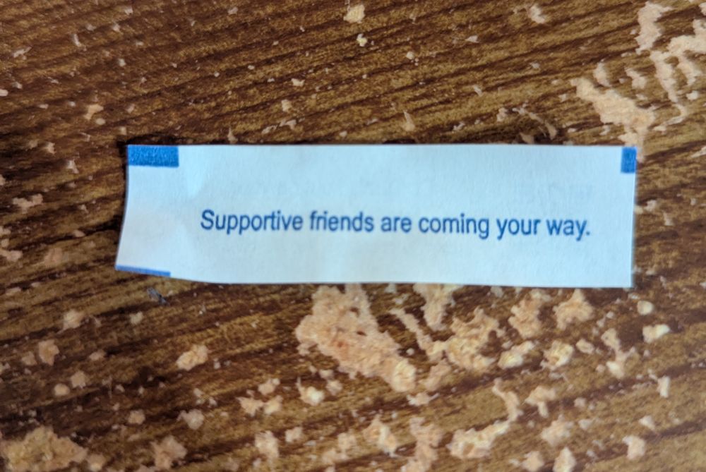 Fortune cookie paper says "Supportive friends are coming your way."