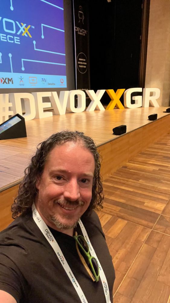 Ben standing in front of the Devoxx Greece stage
