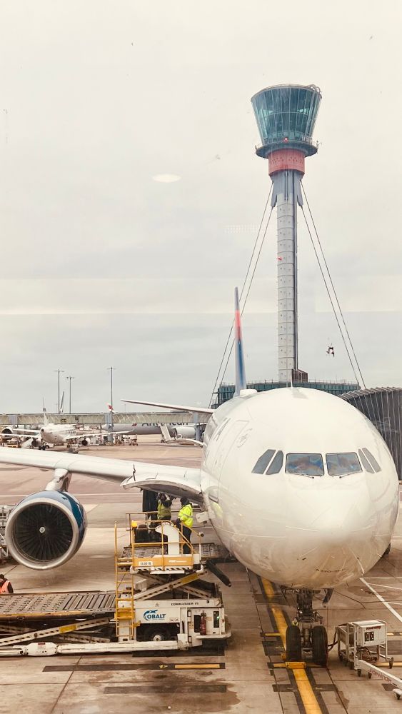 A photo of LHR tower behind a Delta A350 such that it looks like a lidar or camera mounted to the fuselage