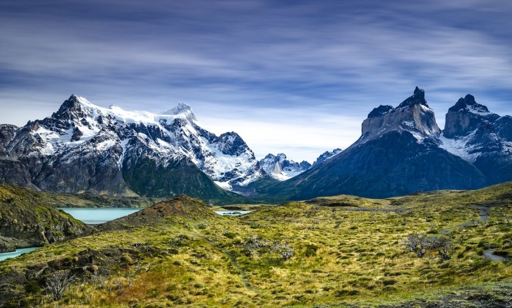 Sharp mountain peaks covered in snow, with milky blue lake in front of them