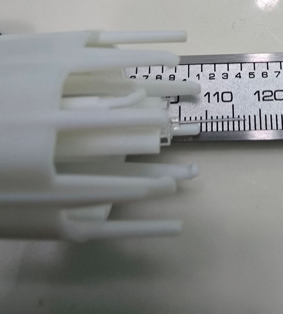 The removed plastic needle cartridge from a Dexcom Stelo, showing the applicator needle in front of a ruler - the needle is about 12mm long.