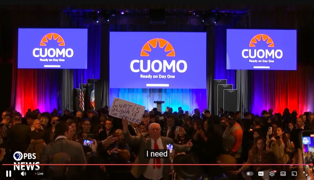 a guy at the andrew cuomo watch party holing up a handwritten sign saying "curtis sliwa is the spoiler" even though mamdani is likely getting a majority of the vote