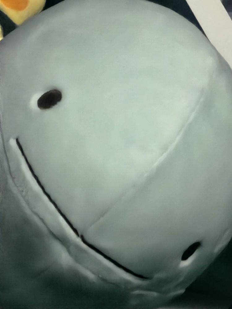 A light teal plush face